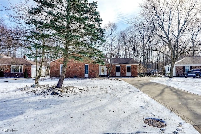 ranch-style home featuring brick siding