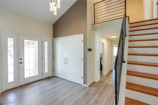 entryway with light wood-style floors, a healthy amount of sunlight, and stairs