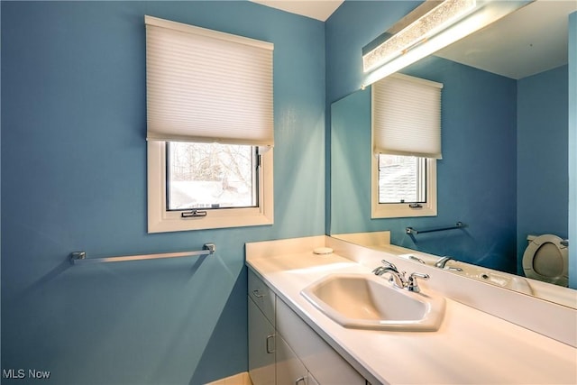 bathroom with plenty of natural light and vanity