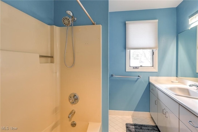 full bathroom featuring baseboards, shower / washtub combination, and vanity