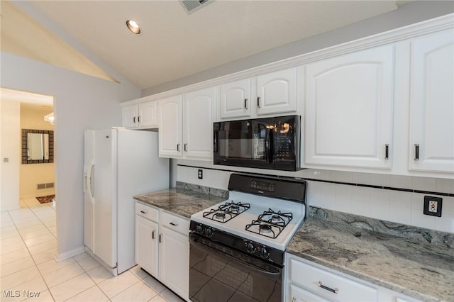 kitchen featuring visible vents, black microwave, range with gas stovetop, and decorative backsplash