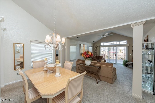 dining area with decorative columns, light colored carpet, vaulted ceiling, baseboards, and ceiling fan with notable chandelier