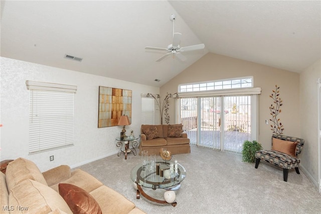 carpeted living room with high vaulted ceiling, baseboards, visible vents, and a ceiling fan