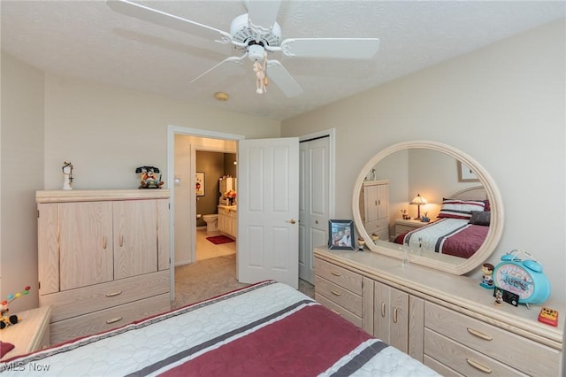 bedroom featuring a closet, carpet flooring, a ceiling fan, and connected bathroom