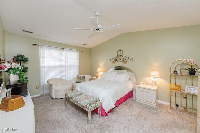 bedroom with lofted ceiling, light carpet, and baseboards