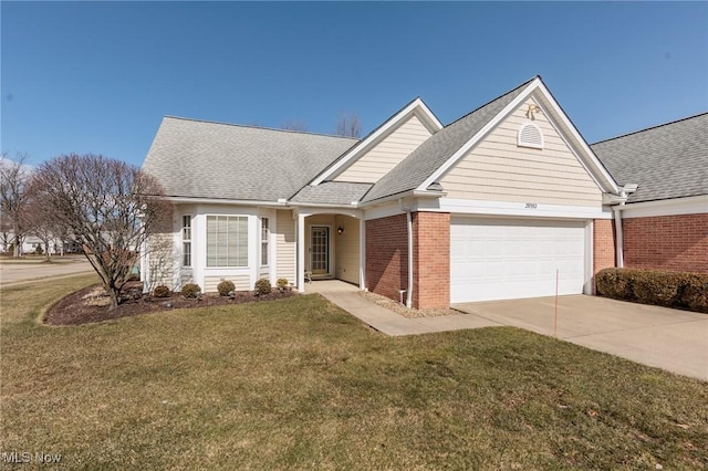 single story home featuring brick siding, roof with shingles, an attached garage, and a front yard