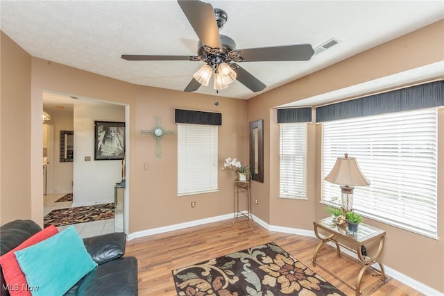 interior space featuring ceiling fan, wood finished floors, and baseboards