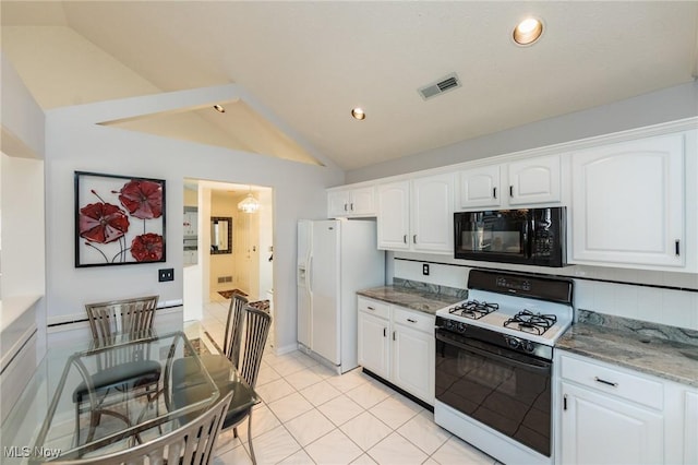 kitchen featuring stone counters, lofted ceiling, white appliances, and white cabinets