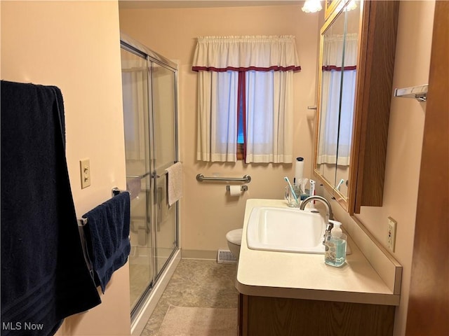 bathroom with a stall shower and vanity