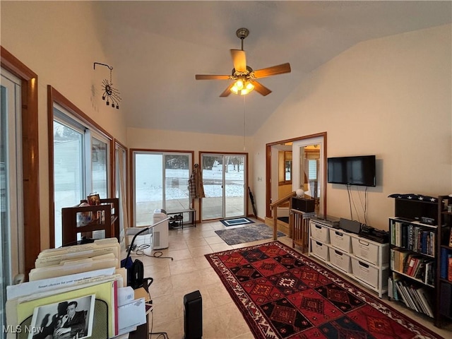 living area featuring lofted ceiling, ceiling fan, and light tile patterned floors