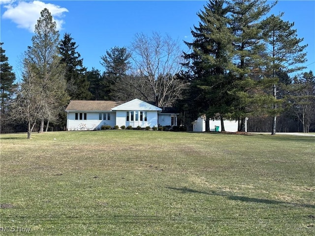 view of front of property with a garage and a front yard