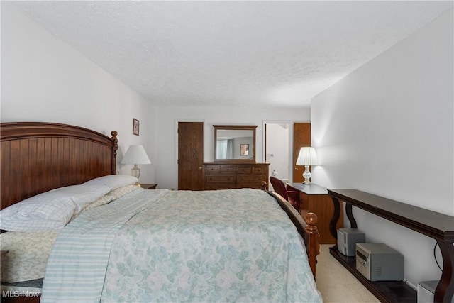 carpeted bedroom featuring a textured ceiling