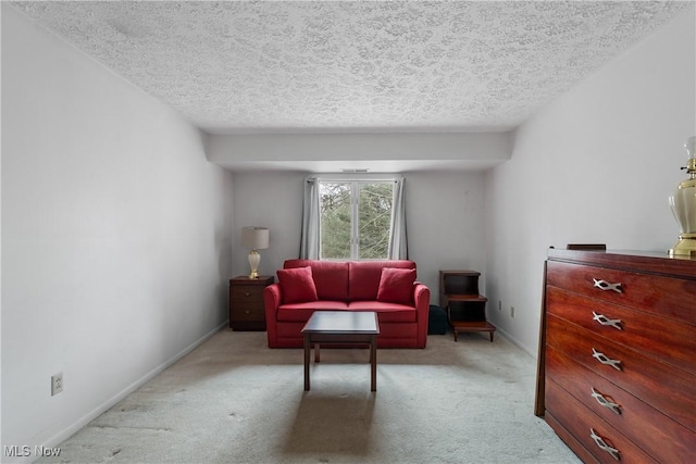 living room featuring a textured ceiling, carpet floors, and baseboards