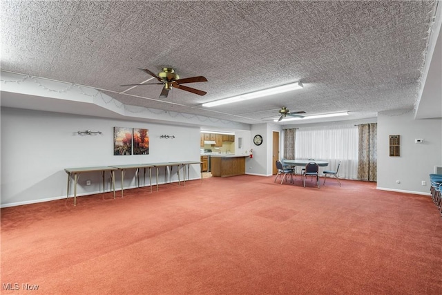 miscellaneous room with baseboards, a textured ceiling, a ceiling fan, and carpet flooring