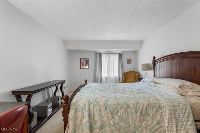 bedroom featuring carpet and a textured ceiling