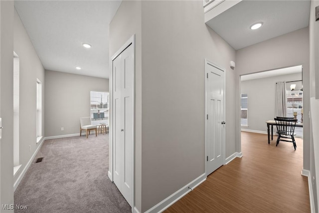 hall with recessed lighting, a healthy amount of sunlight, visible vents, and baseboards