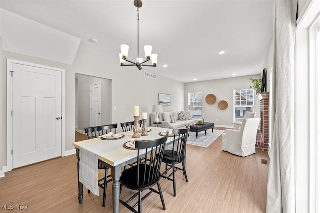 dining area with light wood finished floors, recessed lighting, visible vents, an inviting chandelier, and baseboards