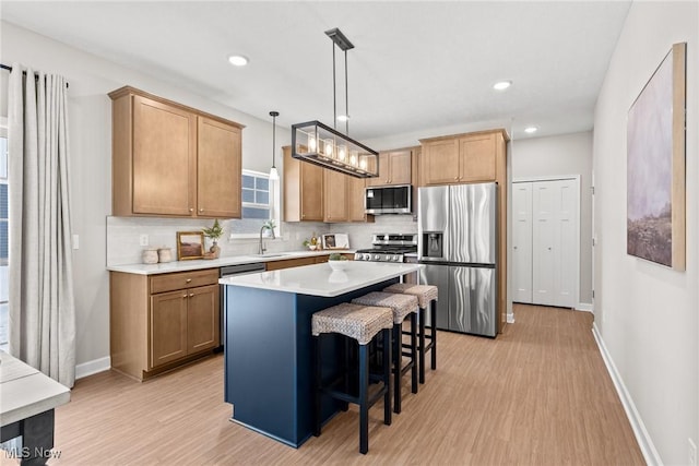 kitchen featuring tasteful backsplash, appliances with stainless steel finishes, a sink, and a center island