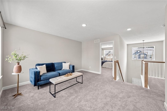 living area featuring carpet, baseboards, and recessed lighting