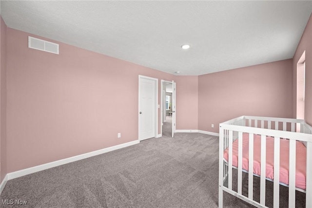 unfurnished bedroom featuring carpet, baseboards, and visible vents