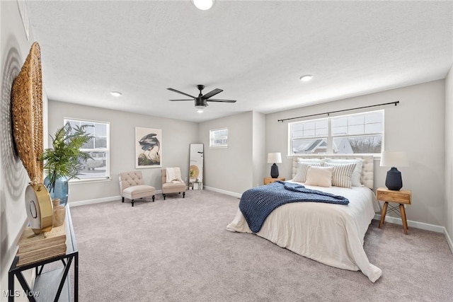 bedroom featuring a textured ceiling, carpet floors, and baseboards