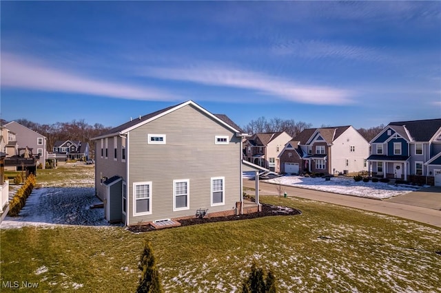 view of property exterior with a residential view and a lawn