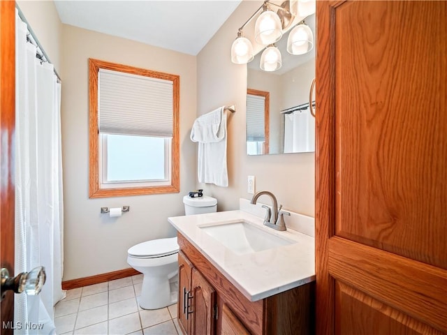 bathroom with baseboards, vanity, toilet, and tile patterned floors