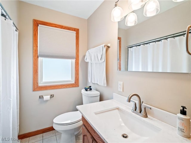 full bathroom featuring toilet, vanity, baseboards, and tile patterned floors