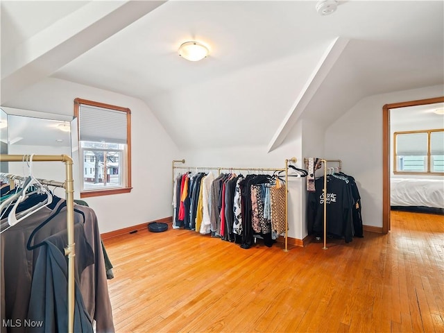 spacious closet featuring vaulted ceiling and hardwood / wood-style floors