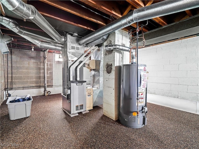 utility room with heating unit, water heater, and visible vents