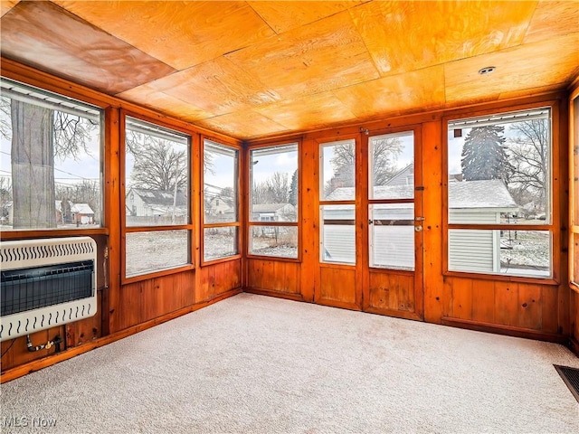 unfurnished sunroom featuring wooden ceiling and heating unit