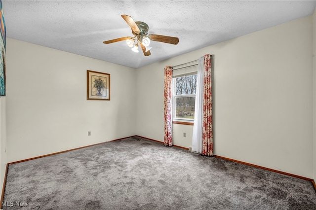 carpeted spare room with a ceiling fan, a textured ceiling, and baseboards