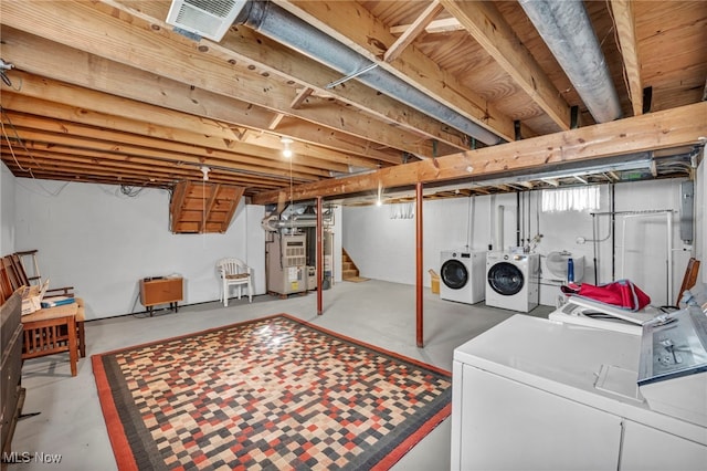 below grade area featuring stairs, separate washer and dryer, visible vents, and heating unit