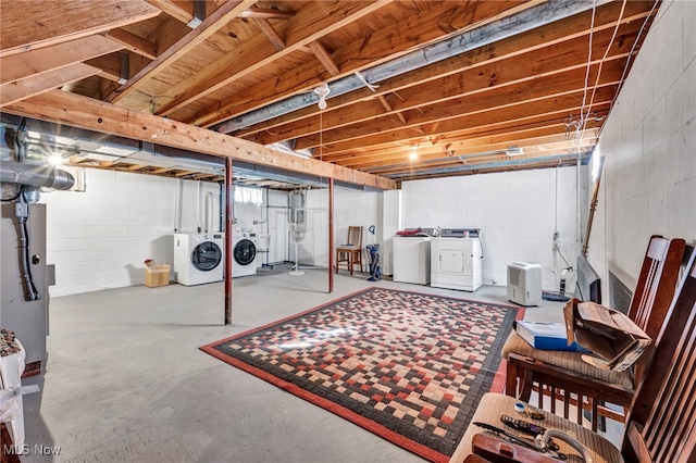 unfinished basement with washing machine and clothes dryer