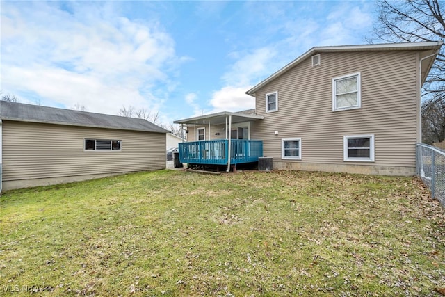 back of property featuring a deck, a yard, central AC unit, and fence