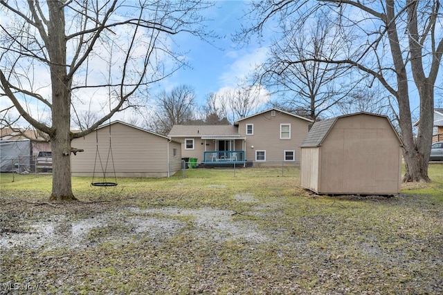 back of property with a storage shed, a yard, and an outdoor structure