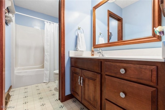 bathroom with vanity, toilet, and shower / bath combo