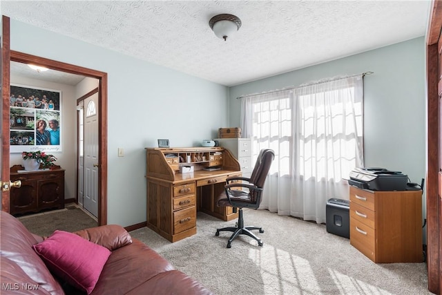 office featuring carpet flooring, a textured ceiling, and baseboards