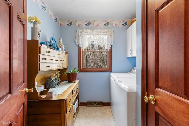 washroom featuring visible vents, cabinet space, separate washer and dryer, light tile patterned floors, and baseboards