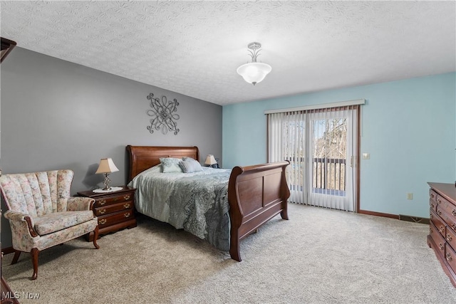 bedroom featuring access to exterior, a textured ceiling, light carpet, and baseboards