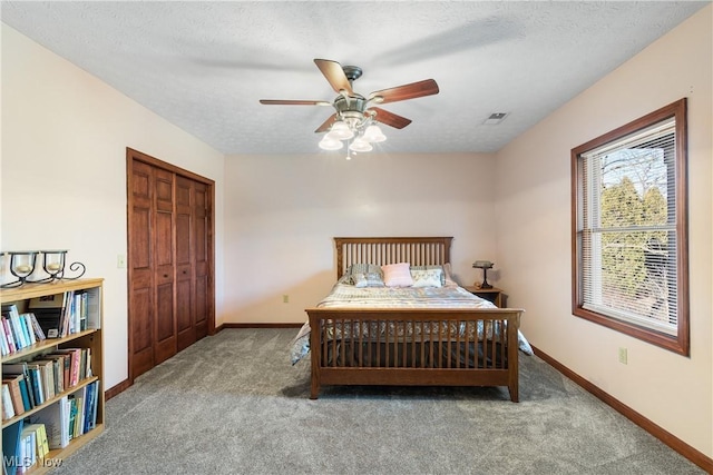 bedroom with visible vents, baseboards, a textured ceiling, and carpet flooring