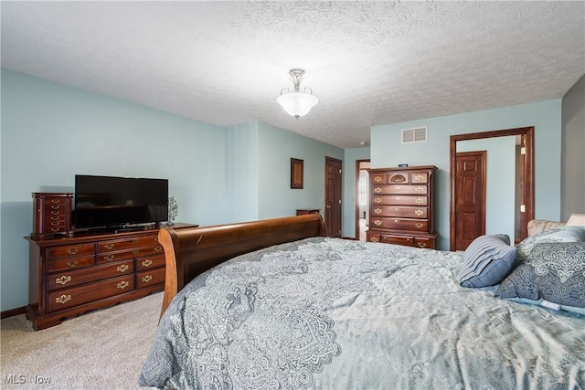 bedroom featuring visible vents, light carpet, a textured ceiling, and baseboards