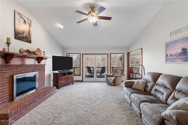 living room featuring visible vents, ceiling fan, carpet, a fireplace, and high vaulted ceiling