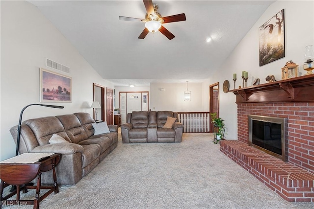 living area with carpet flooring, a fireplace, visible vents, and high vaulted ceiling