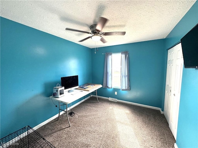 unfurnished office featuring baseboards, visible vents, ceiling fan, a textured ceiling, and carpet floors