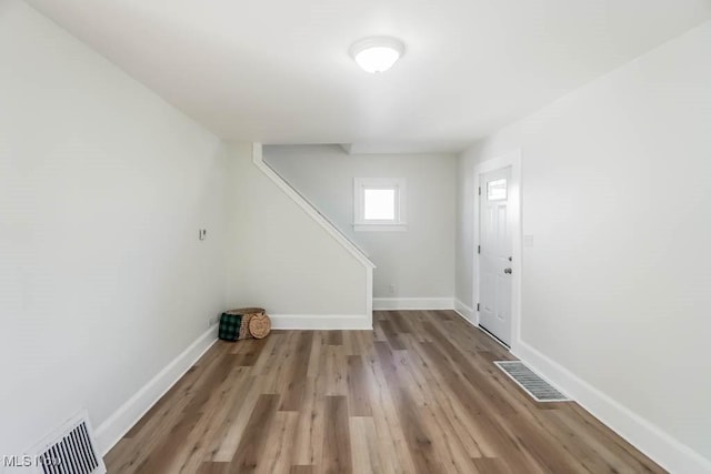 interior space featuring visible vents, baseboards, and wood finished floors