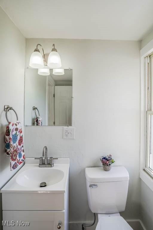 half bathroom with toilet and vanity