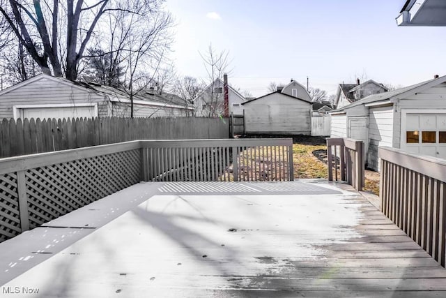 deck with a garage and fence