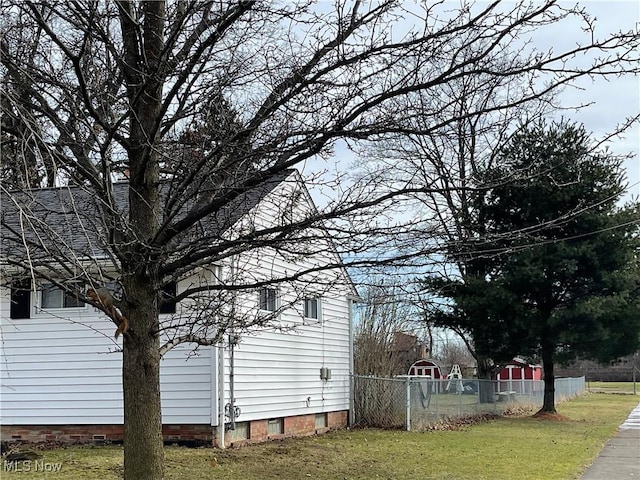 view of property exterior featuring fence and a yard