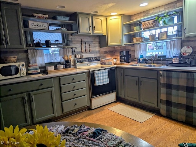 kitchen with open shelves, decorative backsplash, light wood-style floors, a sink, and white appliances